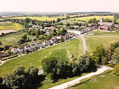 an aerial view of a village with houses and trees at 3 Chestnut Terrace by The Suffolk Cottage Collection in Long Melford