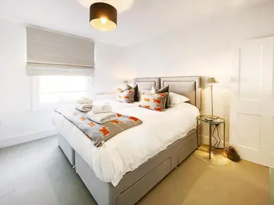 a bedroom with a bed with white sheets and pillows at 3 Chestnut Terrace by The Suffolk Cottage Collection in Long Melford