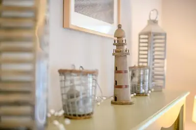 a shelf with two bottles and a lighthouse on it at 2 Bed in Snape oc-wico in Snape