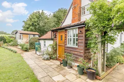 a house with a wooden door and a yard at 2 Bed in Snape oc-wico in Snape