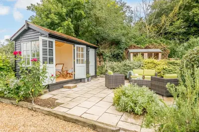 a garden shed with chairs and a patio at 2 Bed in Snape oc-wico in Snape
