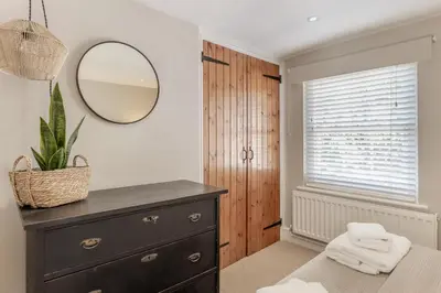 a bedroom with a dresser and a mirror at 1 Bed in Woodbridge oc-11ang in Woodbridge