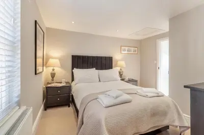 a bedroom with a bed with two towels on it at 1 Bed in Woodbridge oc-11ang in Woodbridge