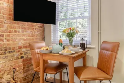 a dining room table with chairs and food on it at 1 Bed in Woodbridge oc-11ang in Woodbridge