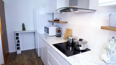 a kitchen with a stove and a microwave at FREE parking, Central Location,1 Bedroom Apartment near Tattersalls in Newmarket