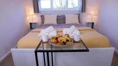 a bedroom with a bed with a bowl of food on a table at FREE parking, Central Location,1 Bedroom Apartment near Tattersalls in Newmarket