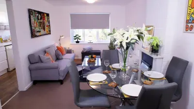a living room with a table and a blue couch at FREE parking, Central Location,1 Bedroom Apartment near Tattersalls in Newmarket
