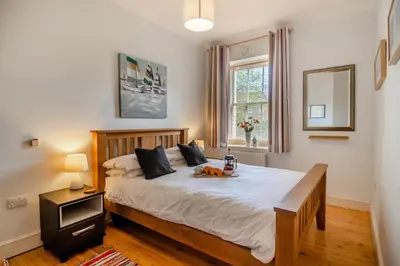 a bedroom with a bed with a dog on it at 2 Bed in Blythburgh oc-wag2 in Blythburgh