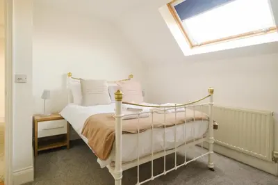 a bedroom with a bed and a skylight at 4 The Birches - Aldeburgh Coastal Cottages in Aldeburgh