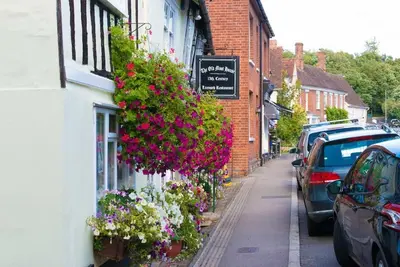 a street with flowers on the side of a building at The Stables, relax in 5 star style and comfort with lovely walks all around in Great Maplestead