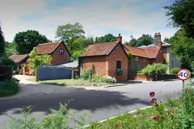 a group of houses on the side of a road at Queenies, an authentic Rural Style coastal cottage in a Nature Reserve in Farnham