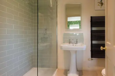 a bathroom with a sink and a glass shower at The Old Steam Mill, luxury, spacious, beautiful grounds, stunning location in Hartest