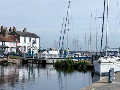 a group of boats are docked at a marina at Navigation Cottage on the Historic Sea Lock overlooking the Nature Reserve in Maldon