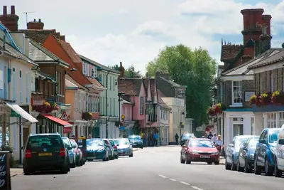 a city street with cars parked on the street at The Old Monkey, a quirky bolthole on the edge of a historic Market Town in Hadleigh