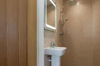 a bathroom with a sink and a mirror at The Hexagon, wow what a location, views over the Essex marshes and sea in West Mersea