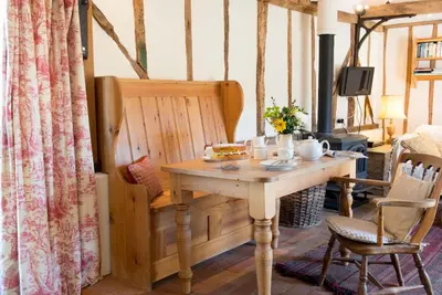 a table with a sandwich on it in a room at Bromans Barn a beautiful cottage by the Sea and Cudmore Nature Reserve in West Mersea