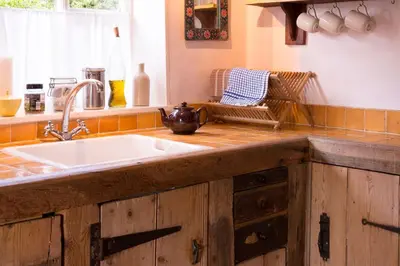 a kitchen with a sink and a counter top at Farm Cottage a cute C17th cottage a walk across the fields to a great pub in Edwardstone