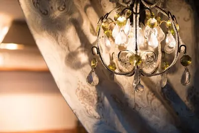 a chandelier hanging from a ceiling in a room at Orchard Cottage cosy rustic comfort just across the fields to a great Pub in Edwardstone