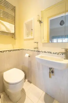 a bathroom with a toilet and a sink at The Old Bakery - Aldeburgh Coastal Cottages in Aldeburgh
