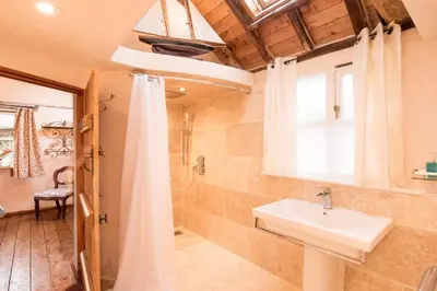 a bathroom with a sink and a shower at Snow Cottage laid back style with footpaths to a great Macro Brewery Pub in Edwardstone