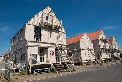 a group of houses sitting on the side of a street at The Wobbin, Remote, Comfort, Sea Views and the beautiful Essex Marshes in West Mersea