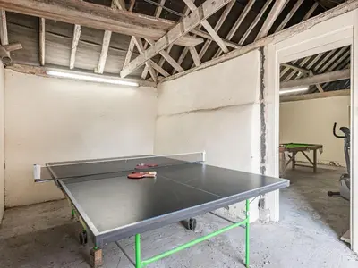 a ping pong table in a room with a ping pong ball at John Fanner Barn - Uk37102 in Mellis