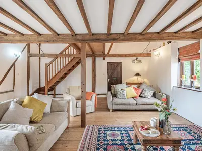 a living room with two couches and a table at John Fanner Barn - Uk37102 in Mellis