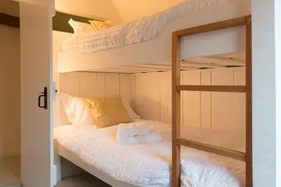 a bunk bed with two bunk beds in a room at Water Cottage, a perfect ancient House in Suffolks prettiest tiny village in Kersey