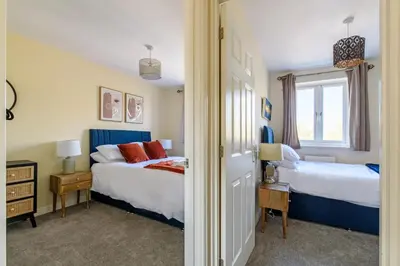 a bedroom with two beds and a window at Charming & Spacious 3BR With Private Parking Near Ipswich in Ipswich