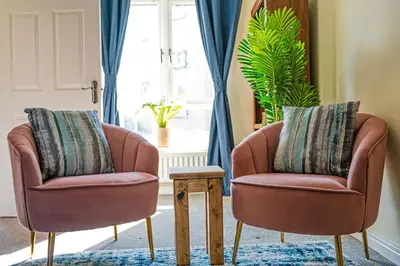 two chairs and a table in a living room at Charming & Spacious 3BR With Private Parking Near Ipswich in Ipswich
