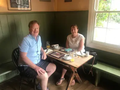 two people sitting at a table in a restaurant at The Compasses in Chelmsford