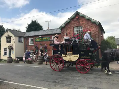 a horse drawn carriage parked in front of a building at The Compasses in Chelmsford