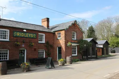 a red brick building with a sign on it at The Compasses in Chelmsford