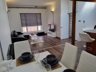 a living room with a dining table and a living room at Modern and spacious two bedroom apartment in Ipswich