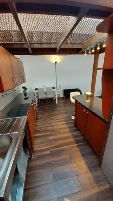 a kitchen with tables and chairs in a room at Modern and spacious two bedroom apartment in Ipswich