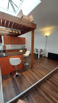 a room with a desk and chairs and a table at Modern and spacious two bedroom apartment in Ipswich