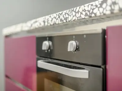 a close up of a black oven in a kitchen at 1 Lamb Barn in Clacton-on-Sea