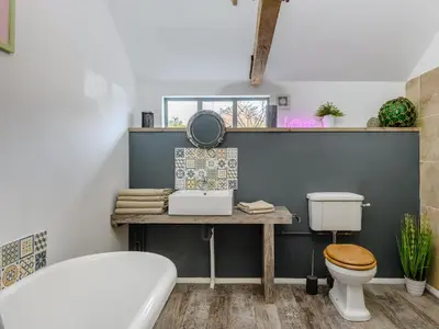 a bathroom with a sink and a toilet at 1 Lamb Barn in Clacton-on-Sea