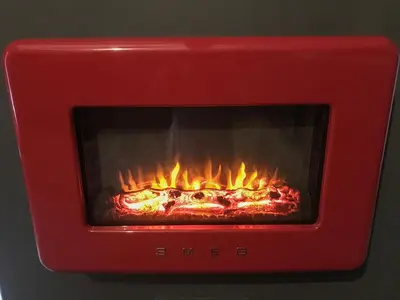a red oven with a fire in it at 1 Lamb Barn in Clacton-on-Sea