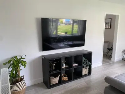 a living room with a flat screen tv on a wall at •11 The Nook in Wivenhoe