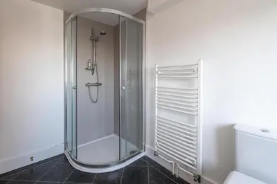 a shower with a glass door in a bathroom at Gun Lodge - Aldeburgh Coastal Cottages in Aldeburgh
