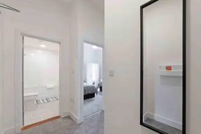 a mirror in a room with a bedroom at Town center apartment in Bishops Stortford in Birchanger