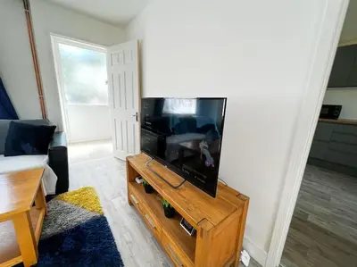 a living room with a large flat screen tv at Starview Apartment - Hawthorne in Colchester