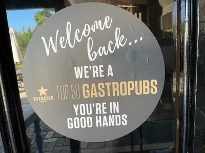 a sign on the door of a store at The Hole In The Wall in Little Wilbraham