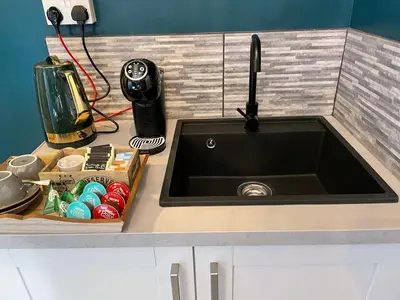 a kitchen counter with a sink and a mixer at The Hole In The Wall in Little Wilbraham