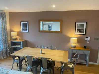 a dining room with a wooden table and chairs at 2 Deben Wharf, Woodbridge in Woodbridge