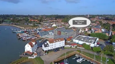 an aerial view of a town with a marina at 2 Deben Wharf, Woodbridge in Woodbridge