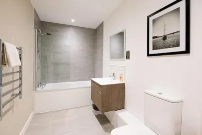 a bathroom with a toilet and a sink and a shower at 2 Deben Wharf, Woodbridge in Woodbridge