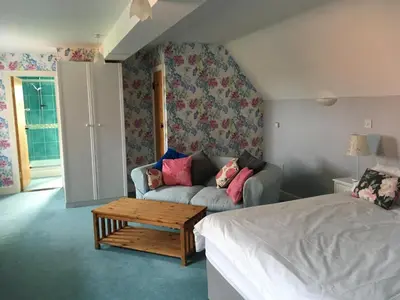 a living room with a couch and a coffee table at Dragonfly Cottage, Rattlesden in Rattlesden