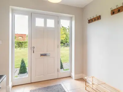 a white door in a room with a window at The Croft in Thetford